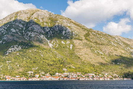 Panorama of Perast, Montenegro, with red rooftops, blue sea, and surrounding mountains