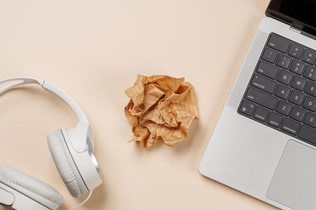 Laptop and stationery on beige workspace, top view with copy space, minimal office backgroundの写真素材