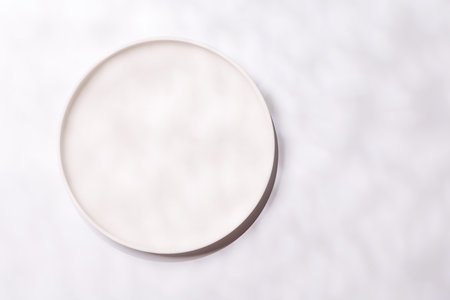 Empty plate on white background, food mockup with natural light. Flat layの写真素材