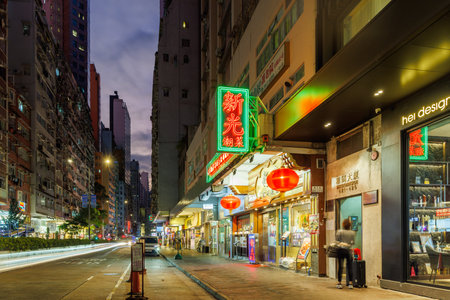 Hong Kong, China - November 29 2025: Busy streets filled with people and neon lights during evening hours in the cityのeditorial素材