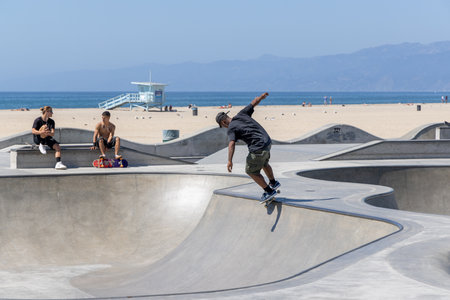Los Angeles, California, United States - September 28 2022: Skaters riding and practicing tricks at the skate park in the Venice Beach area, showing active youth culture and urban lifestyle.のeditorial素材