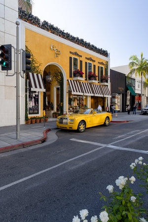 Beverly Hills, California, United States - October 01 2022: View of Rodeo Drive with luxury boutiques, palm trees and traffic, showing one of the most famous shopping streets in Los Angeles.のeditorial素材
