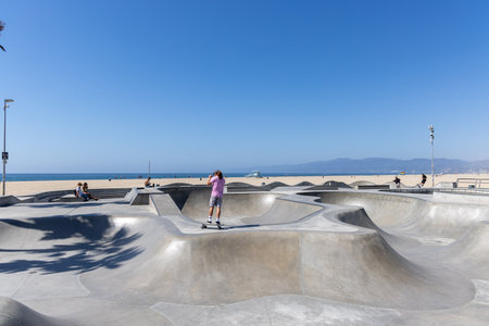 Los Angeles, California, United States - September 28 2022: Skaters riding and practicing tricks at the skate park in the Venice Beach area, showing active youth culture and urban lifestyle.のeditorial素材
