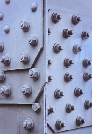 metal plates of gray color fastened by boltsの写真素材