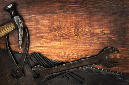 old and rusty tools on wooden backgroundの写真素材