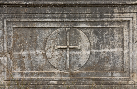Old christian plaque with a cross relief on itの写真素材