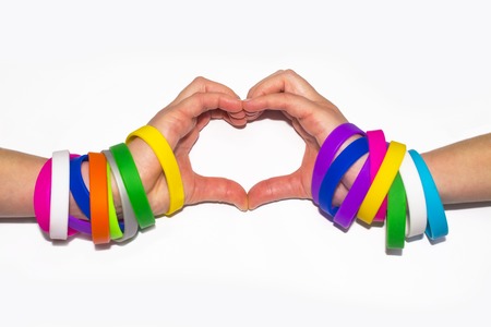 Blank rubber wristbands on wrist arm. Silicone fashion round social bracelet wear on hand. Unity band.の写真素材