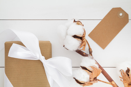 Present and gift tag on white woodの写真素材