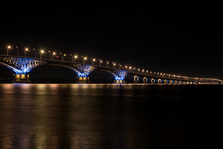 The beautiful bridge in night in light of lamps between the cities of Saratov and Engels through the...
