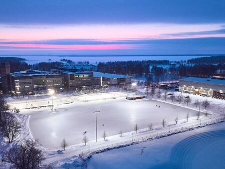 Joensuu, Helsinki  - January 19, 2019: Aerial view of a huge ice rink on the background of a beautiful sunsetのeditorial素材