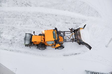 Tractor cleans a street after heavy snow.の写真素材