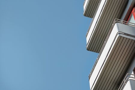 Balconies on a modern apartment building against the blue sky.の写真素材