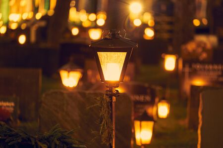Many candles kindling at a cemetery on All Saints' Day