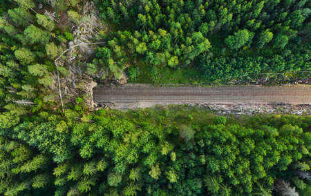 Aerial view of the railway track. The railroad between the hills goes into a tunnel.
