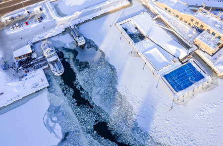 Aerial view of the outdoor heating pool Allas Sea Pool and the Suomenlinna ferry dock on a sunny...