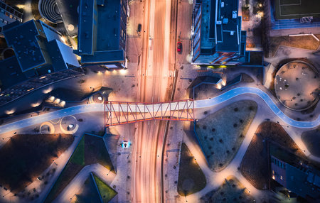 Aerial view of the modern neighborhood Jatkasaari of Helsinki, Finland. Modern Nordic architecture. Orange modern bicycle-pedestrian bridge over the street.の写真素材