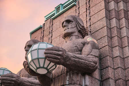 Helsinki, Finland - November 4, 2021: The 'Lantern Carriers' statues at Helsinki Central Railway Station were adorned with the vaccine patch during the COVID-19 pandemic.のeditorial素材
