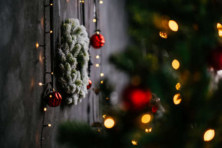New Year 2021 interior with candles, bulbs and bokeh. Room decorated to christmas celebration. Christmas tree with presentsの写真素材