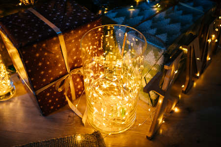 New Year 2021 interior with candles, bulbs and bokeh. Room decorated to christmas celebration....