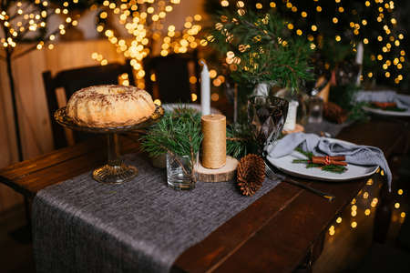 New Year 2021 interior with candles, bulbs and bokeh. Room decorated to christmas celebration. Christmas tree with presentsの写真素材