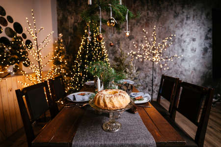 New Year 2021 interior with candles, bulbs and bokeh. Room decorated to christmas celebration. Christmas tree with presentsの写真素材