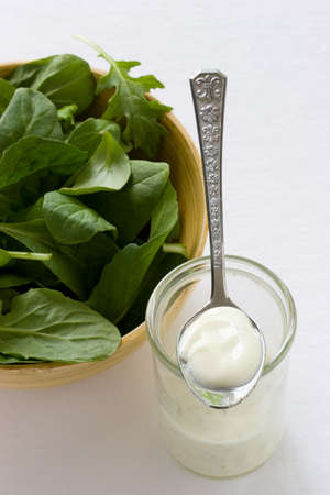 Spinach salad with ranch dressing on the sideの写真素材