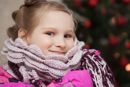 smiling girl next to a Christmas treeの写真素材
