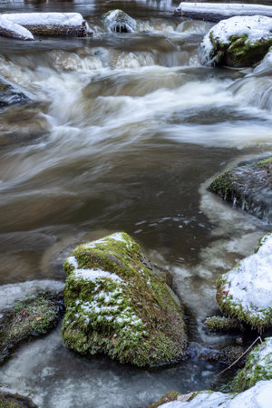 Little cascade with ice. River in cold snowy winterの写真素材