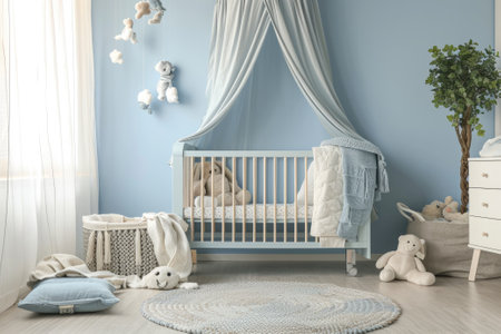 Simple, blue baby bedroom with cot and rug.の素材