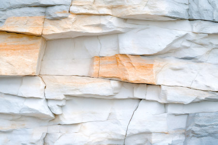 Close-up of layered rock formations showcasing a mix of white and orange hues, creating a natural abstract designの素材