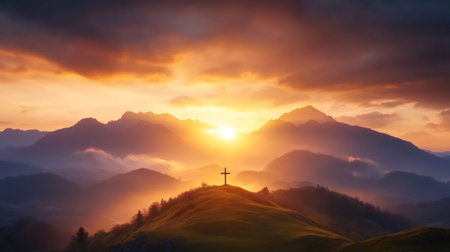 Stunning sunrise creating a breathtaking golden glow over a mountain landscape with a cross on a hilltop, inspiring a sense of peace and spiritualityの素材