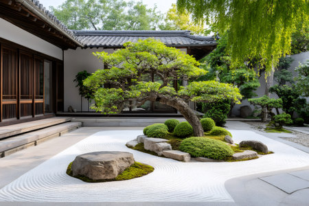 Traditional Japanese zen garden with a decorative tree and raked white gravel is creating a peaceful atmosphereの素材