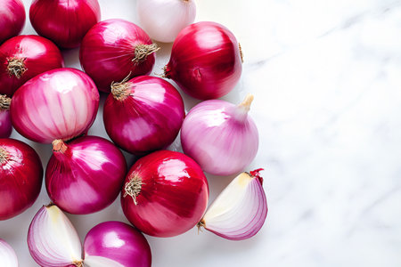 Red onions and a cut one on a marble surface, creating a vibrant and colorful imageの素材