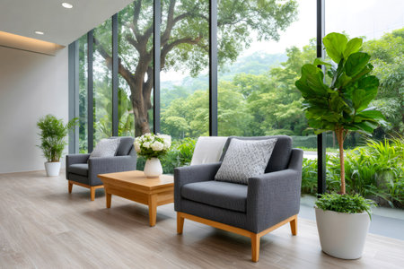 Comfortable armchairs and lush greenery create a relaxing atmosphere in modern interior design with large windows showcasing natureの素材