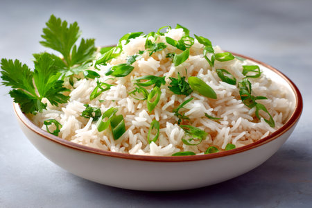 Fluffy basmati rice topped with sliced green onions and parsleyの素材
