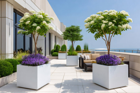Rooftop terrace featuring potted plants, lush greenery, and comfortable outdoor furniture on a sunny dayの素材