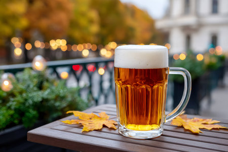 Beer mug on a table enjoying an autumn street cafe settingの素材