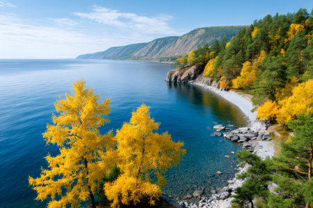 Lake Baikal shoreline showing clear water, a pebble beach, and colorful autumn vegetationの素材