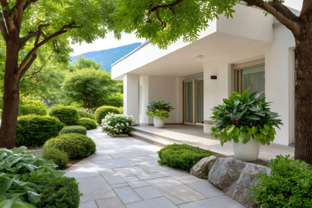 House patio with stone path and green landscaped garden during summer dayの素材