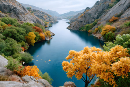 River water winding through a rocky canyon, showing colorful autumn foliage and scenic natureの素材