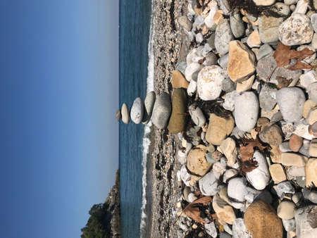 Stones stacked by the beach in a beautiful weather