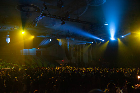 Crowd in front of concert stage with bright rays of light.の写真素材