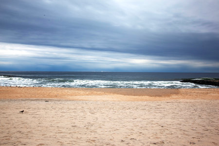 beautiful beach in Algarve, Portugal, on a cloudy dayの写真素材