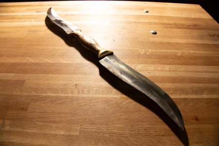 knife on the wooden table with space for your text. Toned.の写真素材