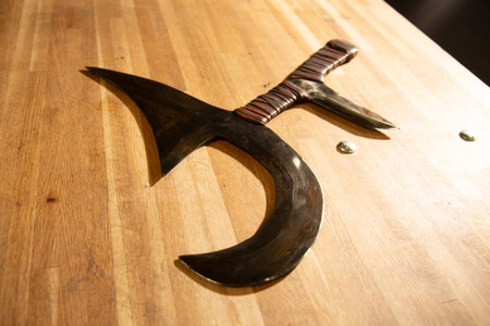 Medieval sword on a wooden table, close-up of photoの写真素材