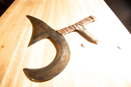 Sword on a wooden table, closeup of photoの写真素材