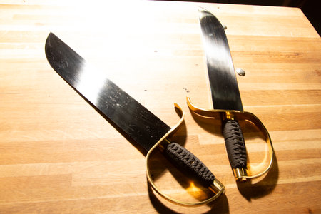 Japanese samurai sword and knife on a wooden table. Selective focus.の写真素材