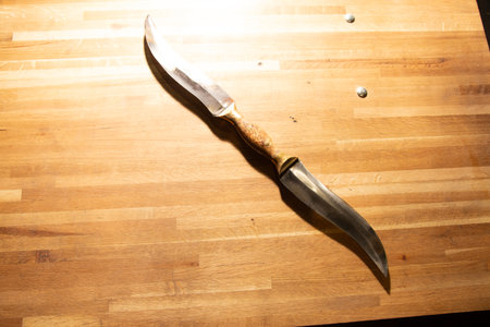Knife on a wooden cutting board. Shallow depth of fieldの写真素材