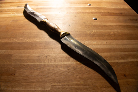 Knife on a wooden table. Knife for hunting and fishing.の写真素材