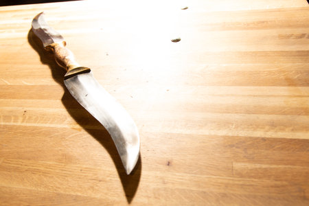 Hunting knife on a wooden table. Selective focus. Toned.の写真素材